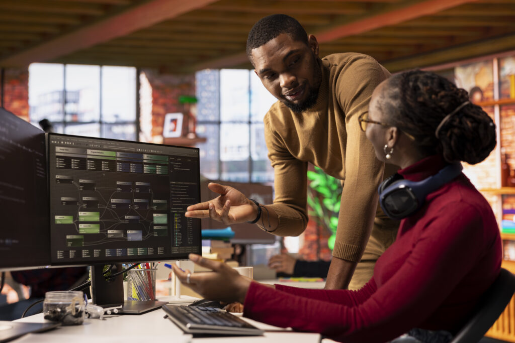 team of tech venture employees collaborating to review code and fix bugs